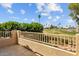 Balcony overlooking the golf course and a serene lake, surrounded by lush greenery and palm trees at 21538 N 59Th Ln, Glendale, AZ 85308