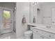 Bathroom featuring a white vanity, toilet, and a glass door to the backyard at 21538 N 59Th Ln, Glendale, AZ 85308