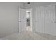 Bedroom with neutral walls and carpet, closet, and view to laundry room at 21538 N 59Th Ln, Glendale, AZ 85308