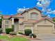 Beautiful two-story home with a tile roof, a front yard featuring lush landscaping, and an attached two-car garage at 21538 N 59Th Ln, Glendale, AZ 85308