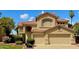 Lovely two-story home featuring a tile roof, neutral-toned exterior, an attached two-car garage, and well-maintained landscaping at 21538 N 59Th Ln, Glendale, AZ 85308
