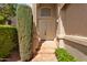 Close-up of the front entrance featuring a double door, tiled entry, and manicured landscaping, creating a warm welcome at 21538 N 59Th Ln, Glendale, AZ 85308