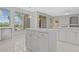 Bright kitchen island featuring white cabinets, tile countertop and a pendant light at 21538 N 59Th Ln, Glendale, AZ 85308