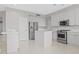 Bright kitchen featuring white cabinets, stainless steel appliances, and a tiled island at 21538 N 59Th Ln, Glendale, AZ 85308
