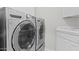 Laundry room with front load washer and dryer in stainless steel at 21538 N 59Th Ln, Glendale, AZ 85308