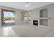 Bright living room featuring a fireplace, neutral tones and a sliding door to a patio at 21538 N 59Th Ln, Glendale, AZ 85308