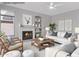Cozy staged living room with a fireplace, built-in shelving, and neutral furniture at 21538 N 59Th Ln, Glendale, AZ 85308