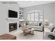 Comfortable staged living room featuring a fireplace, built-in shelves, and modern decor at 21538 N 59Th Ln, Glendale, AZ 85308
