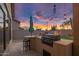 Outdoor kitchen, counter seating and barbeque grill area with view of the backyard at 22036 N 44Th Pl, Phoenix, AZ 85050