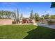 Landscaped backyard with artificial turf, desert plants, a waterfall feature, and a sparkling pool at 22036 N 44Th Pl, Phoenix, AZ 85050