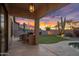 Outdoor kitchen, counter seating and barbeque grill area overlooking artificial turf and desert landscaping at 22036 N 44Th Pl, Phoenix, AZ 85050