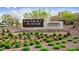 A sign for Desert Ridge Marketplace surrounded by green bushes and trees at 22036 N 44Th Pl, Phoenix, AZ 85050