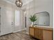 Bright and welcoming entryway with wood-look tile flooring, a modern light fixture, and stylish decor at 22036 N 44Th Pl, Phoenix, AZ 85050