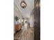 Inviting entryway with wood-look tile flooring, stylish light fixture, and modern accent furniture at 22036 N 44Th Pl, Phoenix, AZ 85050