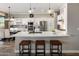 Modern kitchen featuring white cabinetry, stainless steel appliances, and a large island with bar seating at 22036 N 44Th Pl, Phoenix, AZ 85050