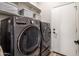 Laundry room features modern washer and dryer, built-in storage and a white door at 22036 N 44Th Pl, Phoenix, AZ 85050