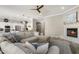 Open-concept living room featuring a fireplace, ceiling fan, and views into the modern kitchen at 22036 N 44Th Pl, Phoenix, AZ 85050
