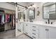 Sleek main bathroom with double vanities, modern fixtures, and a walk-in closet with ample storage at 22036 N 44Th Pl, Phoenix, AZ 85050