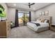 Serene main bedroom with a king bed, plush carpet, and sliding glass doors to the backyard at 22036 N 44Th Pl, Phoenix, AZ 85050