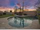 Backyard pool with desert landscaping and artificial turf at sunset at 22036 N 44Th Pl, Phoenix, AZ 85050