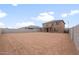 Large backyard with cinder block fence, and a covered patio on a two-story house at 25147 W Atlanta Ave, Buckeye, AZ 85326