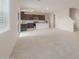 Expansive open-concept living room and kitchen with tile flooring and stairs to the second floor at 25147 W Atlanta Ave, Buckeye, AZ 85326