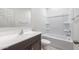 Bathroom with a large vanity, white sink, tub, shower, and toilet at 25224 W Chanute Pass, Buckeye, AZ 85326