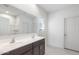 Bathroom boasts double sinks with a large mirror, and a door for privacy at 25224 W Chanute Pass, Buckeye, AZ 85326