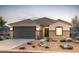 Charming single-story home with a well-manicured front yard and a two car garage at 25224 W Chanute Pass, Buckeye, AZ 85326