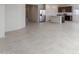 Open-concept living area featuring a kitchen with stainless steel appliances and a large tile floor at 25224 W Chanute Pass, Buckeye, AZ 85326