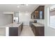 Open kitchen design with stainless steel appliances, granite countertops and a breakfast bar at 25224 W Chanute Pass, Buckeye, AZ 85326