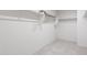 Walk-in closet features shelves, closet rods and neutral carpet at 25224 W Chanute Pass, Buckeye, AZ 85326