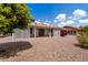 This charming backyard is landscaped with pea gravel, mature trees, pretty bougainvillea, and a covered patio at 2736 Leisure World --, Mesa, AZ 85206