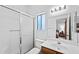 Bright bathroom features a shower over tub, neutral tiling and a mirrored vanity with decorative light at 2736 Leisure World --, Mesa, AZ 85206