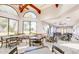 Spacious dining room with tables and chairs, offering views through large arched windows at 2736 Leisure World --, Mesa, AZ 85206