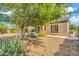 Lush backyard featuring desert landscaping and mature shade trees at 27614 N 129Th Ln, Peoria, AZ 85383