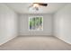 Bright, empty bedroom with neutral carpet, plantation shutters, and ceiling fan at 27614 N 129Th Ln, Peoria, AZ 85383