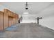 Spacious garage with built-in cabinets, utility sink, and ample storage space for vehicles and tools at 27614 N 129Th Ln, Peoria, AZ 85383