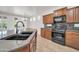 Kitchen featuring granite countertops, wood cabinets, stainless steel appliances and natural light from the window at 27614 N 129Th Ln, Peoria, AZ 85383