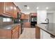 Kitchen featuring wood cabinets, granite countertops, tile backsplash and stainless steel appliances at 27614 N 129Th Ln, Peoria, AZ 85383