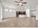 Open-concept living room features dark cabinets, a breakfast bar, and tile flooring at 27614 N 129Th Ln, Peoria, AZ 85383