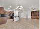 Living room with dark cabinets, black appliances, tile floors, and a breakfast bar at 27614 N 129Th Ln, Peoria, AZ 85383