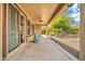 Covered patio with a tranquil water feature and views of the landscaped yard at 27614 N 129Th Ln, Peoria, AZ 85383