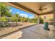 Covered patio with desert-style landscaping, including cacti and palm trees at 27614 N 129Th Ln, Peoria, AZ 85383