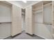 Spacious walk-in closet with custom built-in shelving and cabinetry for ample storage and organization at 27614 N 129Th Ln, Peoria, AZ 85383