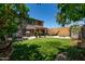 Lush backyard featuring a trampoline, shade sails, and a stone fire pit at 29431 N 23Rd Dr Dr, Phoenix, AZ 85085