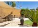 Outdoor patio space with a fire pit, dining area, and lush greenery at 29431 N 23Rd Dr Dr, Phoenix, AZ 85085