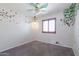 Bright bedroom with charming butterfly and tree decals and a unique ceiling fan at 29431 N 23Rd Dr Dr, Phoenix, AZ 85085