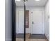 Hallway with a mirror, wooden shuttered window and white doors at 29431 N 23Rd Dr Dr, Phoenix, AZ 85085
