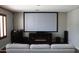 A home theater room with a large screen, fireplace, and comfortable seating at 29431 N 23Rd Dr Dr, Phoenix, AZ 85085